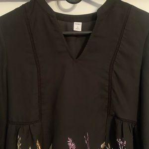 Black dress with floral detail.